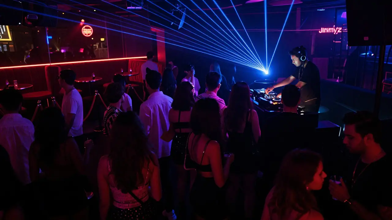 Crowded nightclub with neon lights, dancing crowd, and DJ on stage under pulsing lasers.